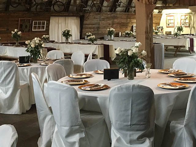 round tables with white chairs at the barn at chestnut ridge