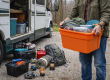 Camper organizing gear and preparing RV for upcoming camping season